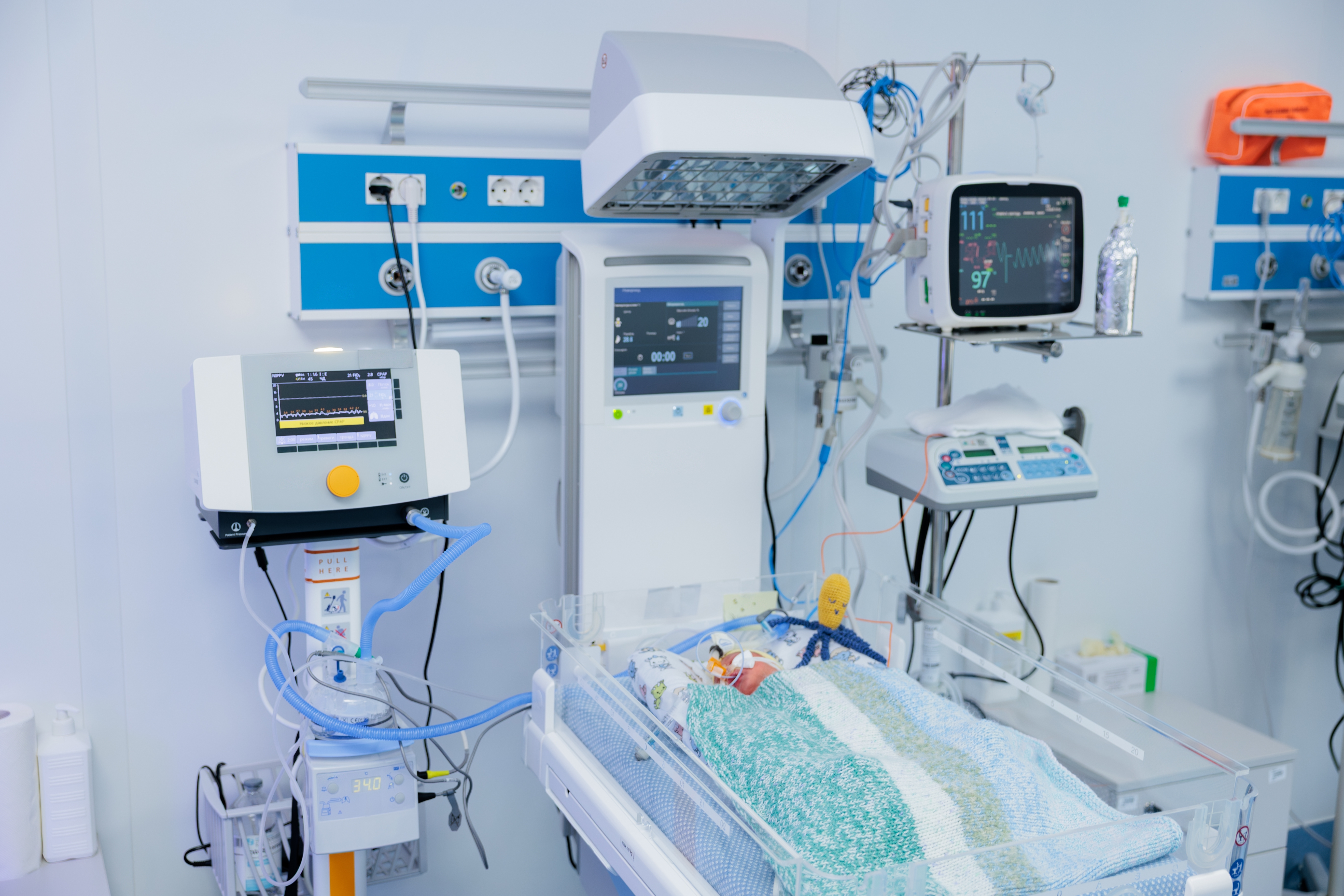 An infant hooked up to machines in a hospital's NICU.