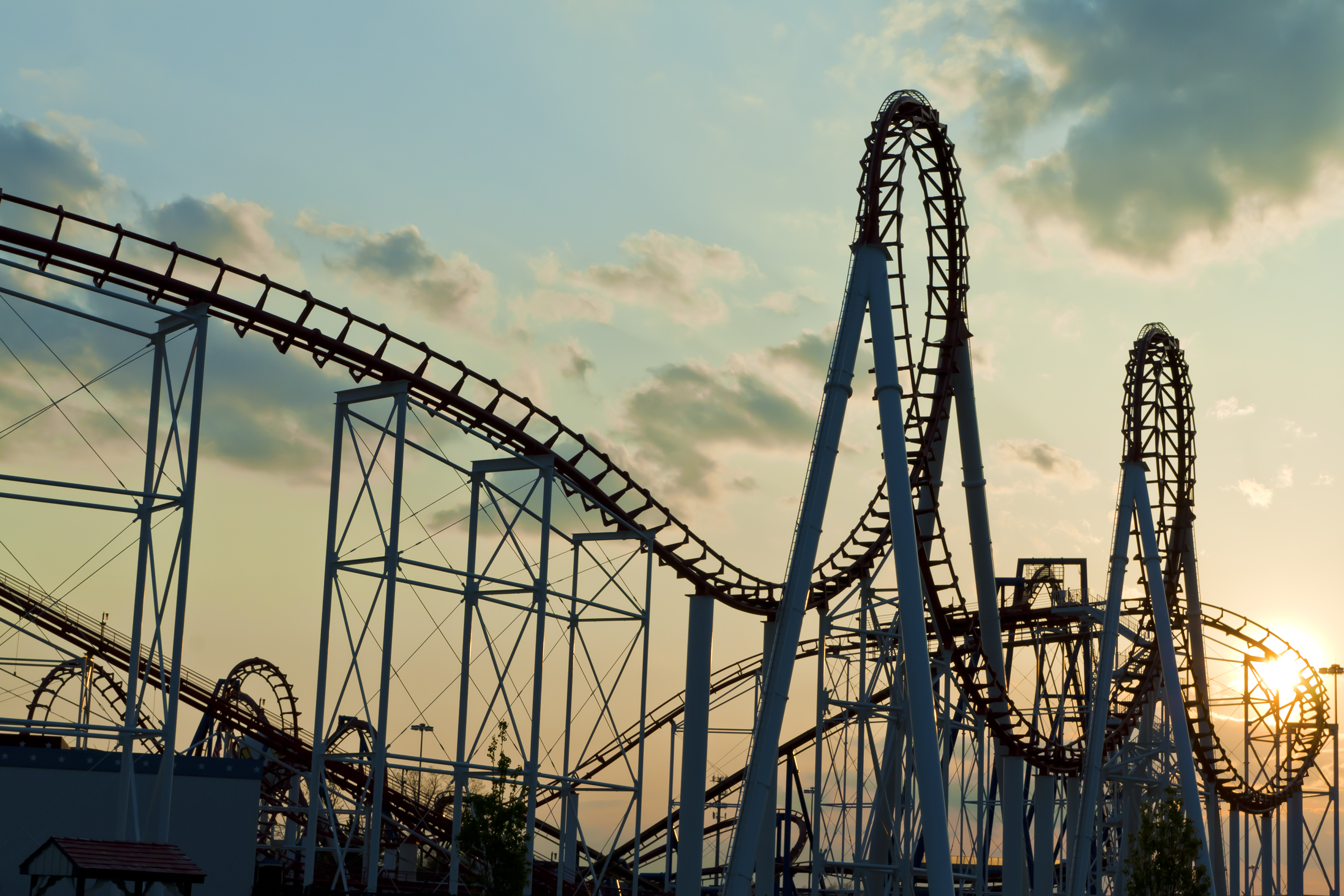 A steel roller coaster at sunset.